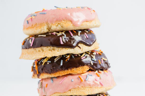 pink and chocolate glazed donuts stacked up