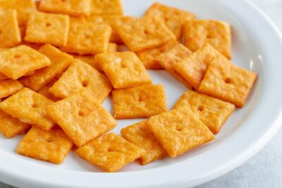 A plate of homemade cheez-its on a white plate.