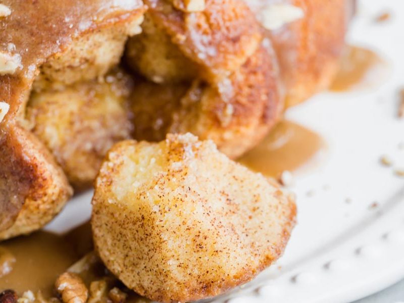 a piece of a pull-apart bread coated with cinnamon on a plate