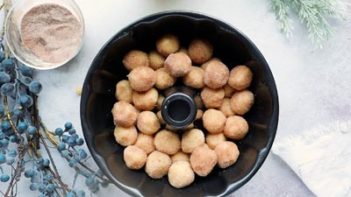 balls of cinnamon sugar coated pastry balls in a bundt pan