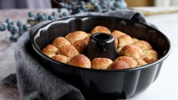 baked monkey bread in a bundt pan next to a gray towel
