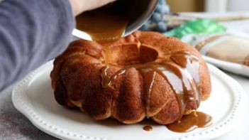 pouring caramel syrup onto a bundt cake