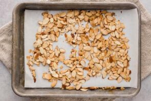a baking sheet with toasted almond slice scattered around