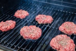 salt and seasoning sprinkled on burger patties