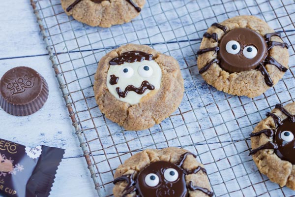 peanut butter cup cookies decorated like spiders and creepy zombies