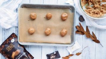 peanut butter balls on a parchement lined baking tray