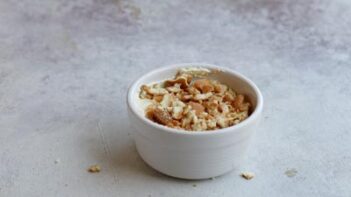 Crushed vanilla wafers on top of banana pudding.