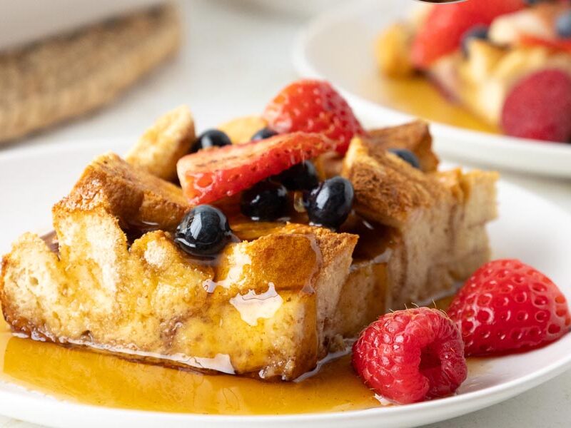 High-protein French toast casserole with sugar-free maple syrup and mixed berries.