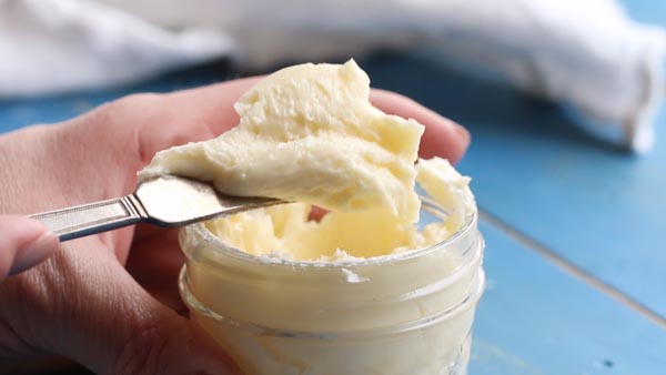 scooping out grass fed butter with a butter knife