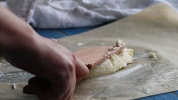 squeezing out excess buttermilk with paddles