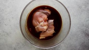 chicken thighs in a bowl of marinade