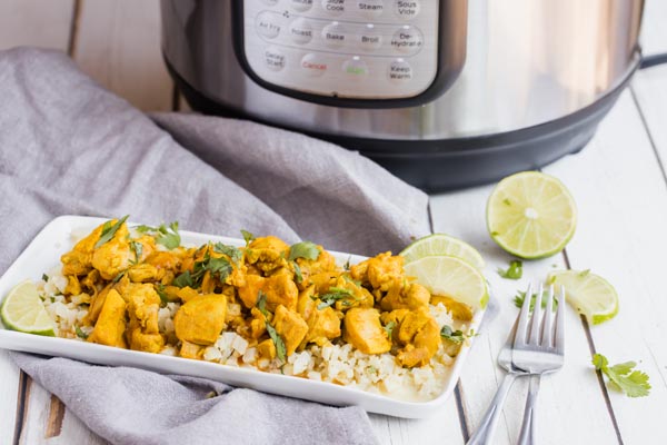 creamy keto butter chicken on a rectangle plate in front of an instant pot