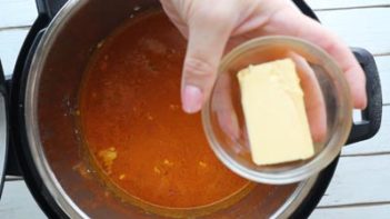 butter in a small dish being added to an instant pot dinner