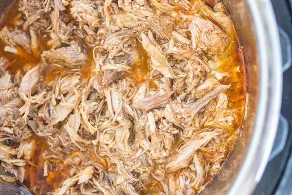 shredded pulled pork in the liner of an instant pot