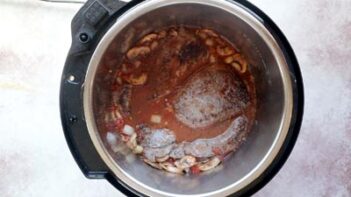 steak in liquid inside an instant pot