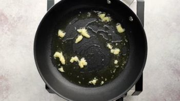 garlic sautéing in a skillet