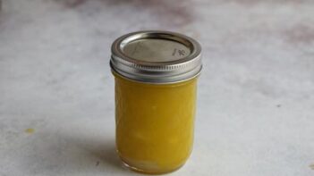 A mason jar with lemon vinaigrette dressing.