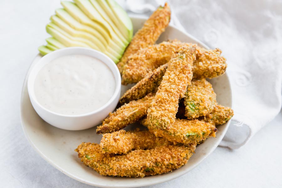 side dish of low carb breaded avocado fries with a side of ranch