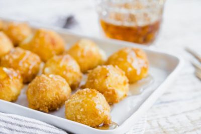 crispy panko coated goat cheese balls with sugar free syrup on top