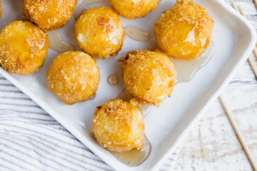 sticky syrup on round balls of crispy cheese