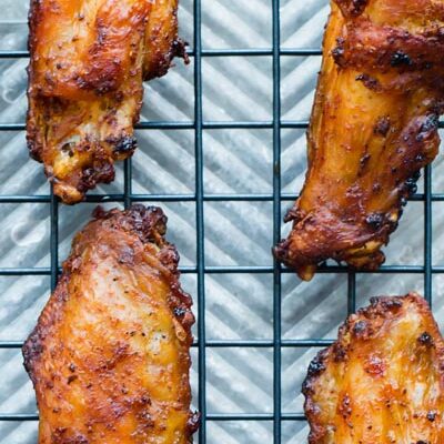 Close up photo showing air fried crispy chicken wings on a tray.