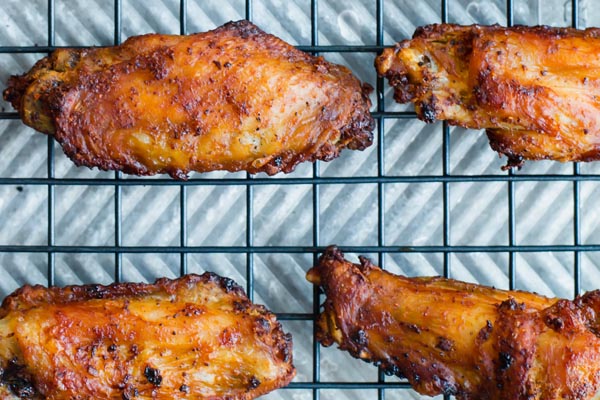 close-up of crispy chicken wings on a wire rack
