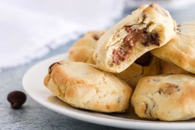 a bunch of golden brown chocolate chip cookies on a plate