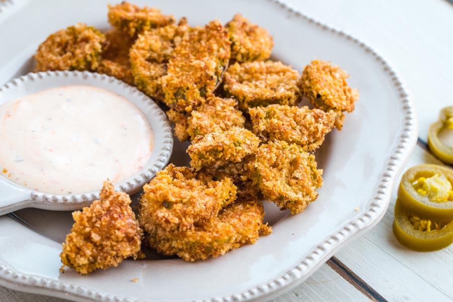 keto breaded jalapenos fried in the air fryer on a plate with a side of ranch