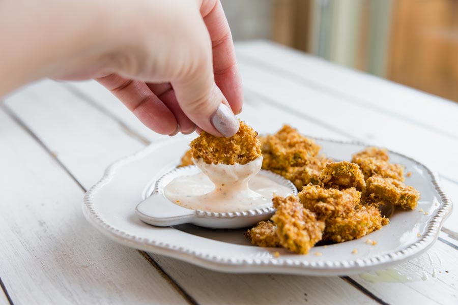 dipping a fried jalapeno in ranch