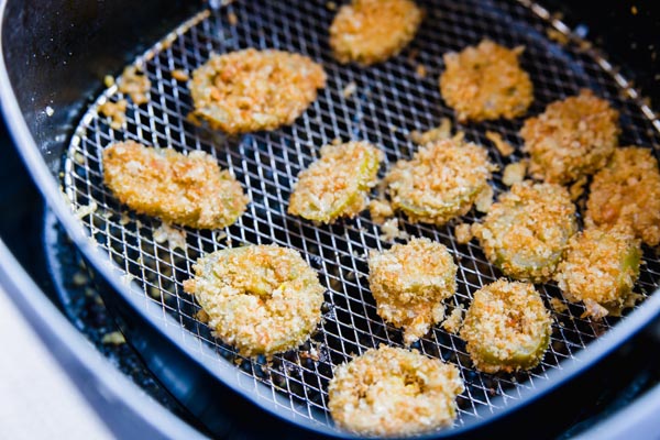 breaded keto jalapeno slices reheating in the air fryer