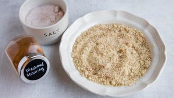 almond flour in a bowl with salt and cajun seasoning next to it