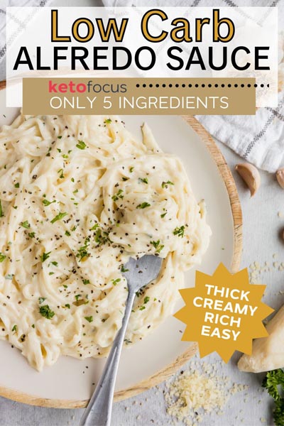 A plate of fettucine alfredo with a fork scooping up pasta.