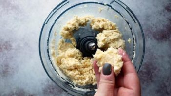 pinching off pie dough in a food processor