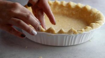 molding the edges of an unbaked pie crust