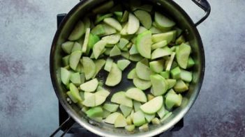 a skillet cooking squash slices