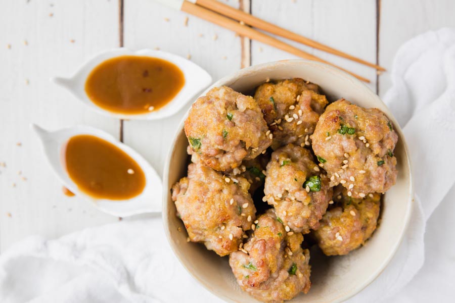 asian meatballs topped with sesame seeds in a bowl