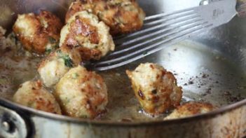 meatballs cooking in a skillet