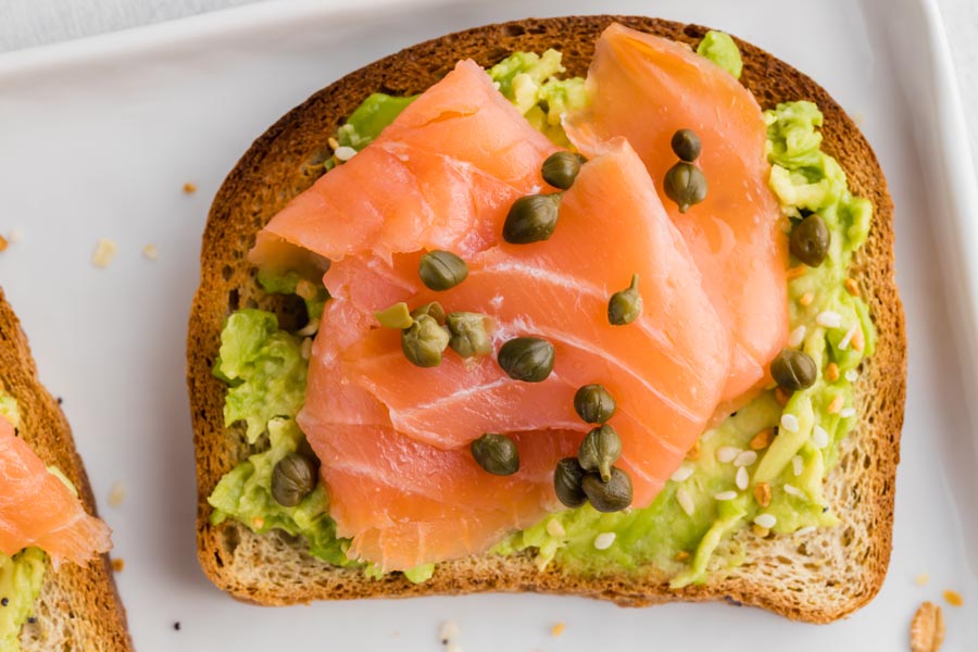 close up of a smoked salmon avocado toast with capers