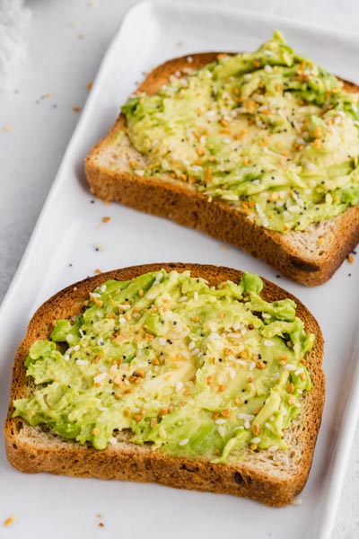 two slices of avocado toast on a plate