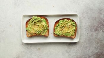 two slices of toast with avocado smashed on