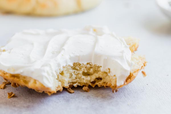 a bite taken out of a bagel with cream cheese