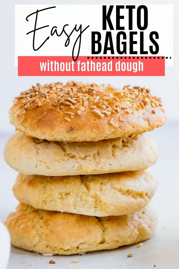 a stack of four bagels, one topped with diced onions
