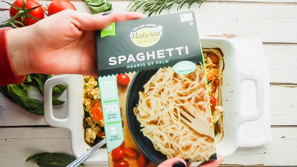 holding a box of natural heaven spaghetti noodles