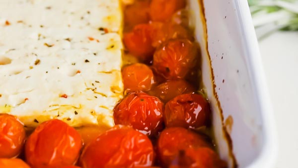 roasted tomatoes with melted feta cheese in the center