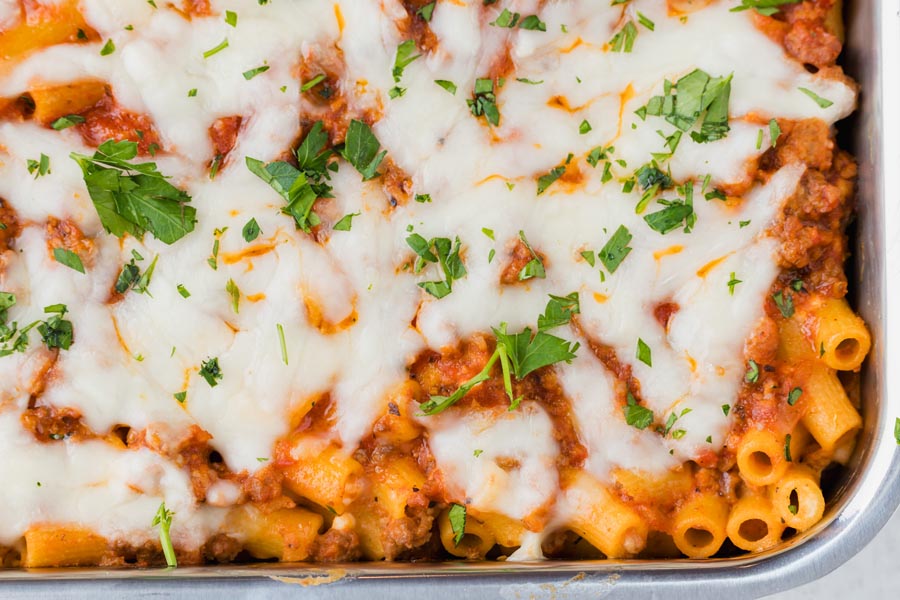 A keto baked ziti casserole topped with a meaty red sauce and mozzarella cheese.