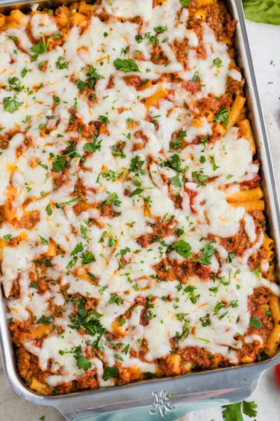 Overhead shot of a ziti casserole recipe from the Pioneer Woman topped with chopped parsley.