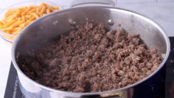 A skillet with browned and cooked ground beef.