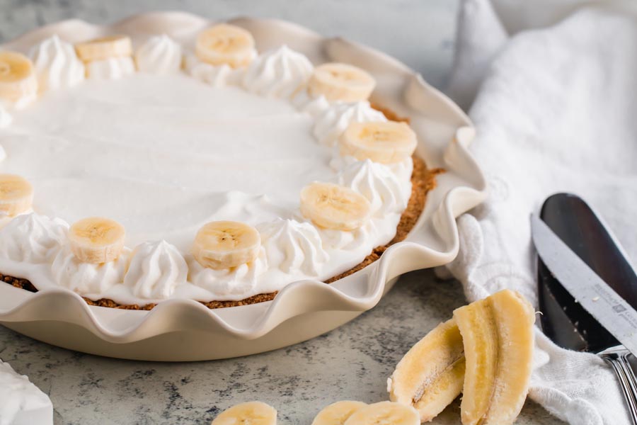 silky keto banana cream pie with homemade whipped cream on top