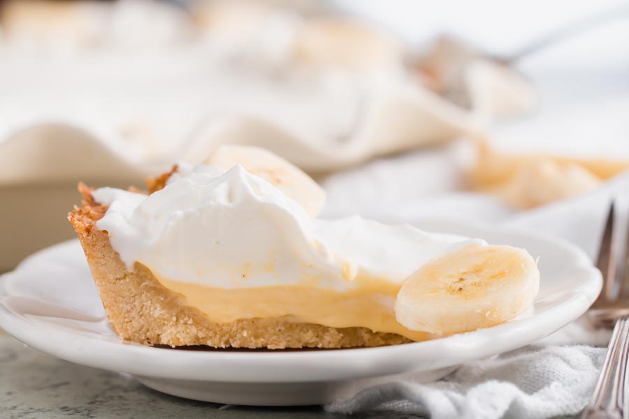 slice of creamy low carb banana cream pie on a white plate