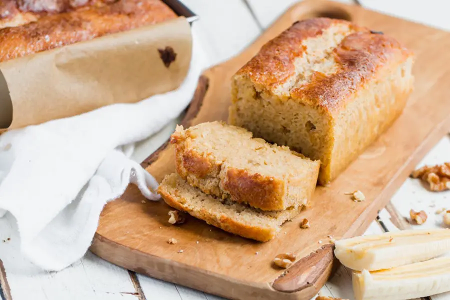 cut up slices of sugar free banana nut bread on a cutting board